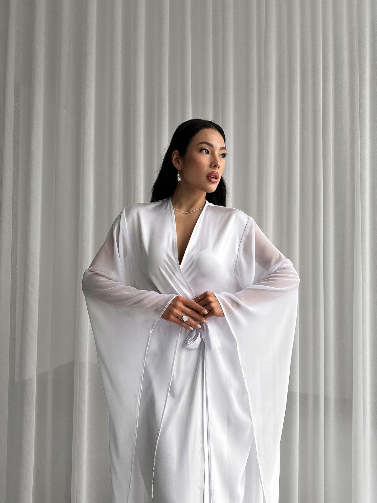 Indulge in opulent comfort with our Long Silky Robe. Chiffon extra-long kimono sleeves add an ethereal flair, perfect for moments of relaxation. Okiya Studio