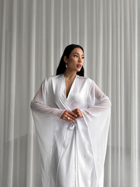 Indulge in opulent comfort with our Long Silky Robe. Chiffon extra-long kimono sleeves add an ethereal flair, perfect for moments of relaxation. Okiya Studio