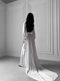 Okiya Studio. Step into your bridal morning with grace and glamour in our Extra Long Robe. The tie waist, open front, and long sleeves with button cuffs ensure a perfect balance of comfort and bridal allure.