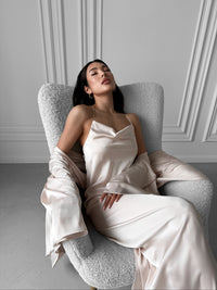 Experience the allure of our Kimono Robe and Nightgown Set—a harmonious blend of style and affordability. The Kimono Robe, featuring a tie waist, open front, and kimono sleeves, perfectly complements the Nightgown with adjustable straps, A-line design, fitted waist, open back, and floor length. Crafted in sumptuous silky fabric, this set is an exquisite choice for bridal robes, wedding mornings, and those who desire luxurious loungewear at a special price.