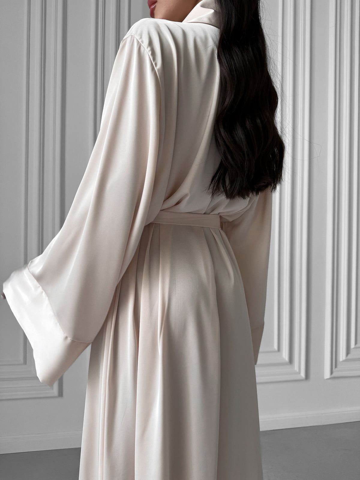 Wrap yourself in elegance with our Long Silky Robe featuring a Shawl Collar and seductive side slits. Crafted from sumptuous silky fabric, this robe offers a perfect blend of sophistication and comfort for your lounging pleasure. Okiya Studio