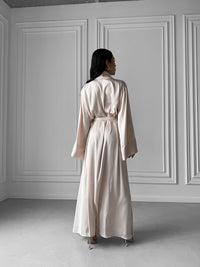 Okiya Studio. Luxury redefined in our Long Silky Robe with Shawl Collar, featuring alluring side slits. Immerse yourself in the opulent embrace of silky fabric, indulging in the perfect balance of comfort and chic sophistication