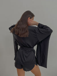 Kimono & Shorts Silky Pajama Set
A close-up of the luxurious silk fabric, highlighting the intricate embroidery on the kimono sleeves and the comfortable shorts. Okiya Studio