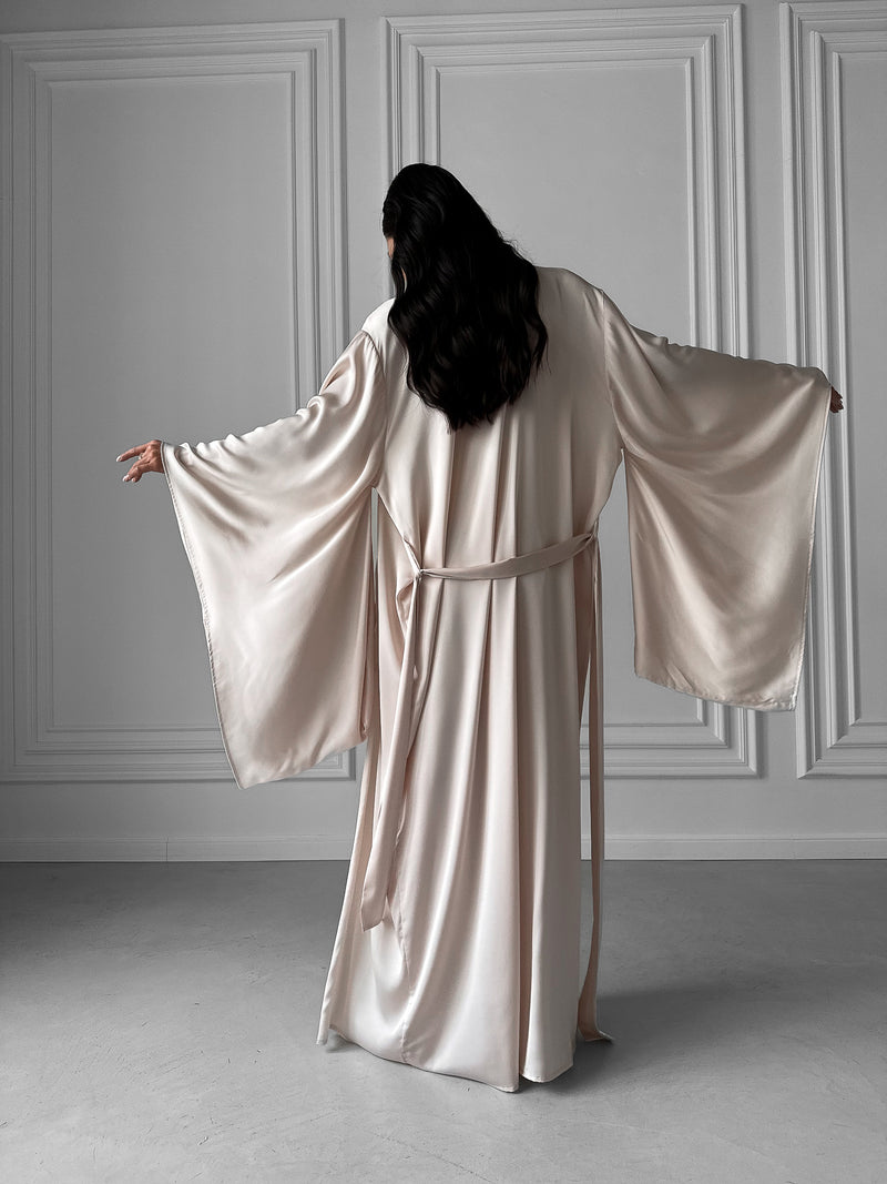 Elevate your loungewear with our Kimono Robe and Nightgown Set—a symphony of elegance and savings. The Kimono Robe, adorned with a tie waist, open front, and kimono sleeves, pairs seamlessly with the Nightgown featuring adjustable straps, A-line design, fitted waist, open back, and floor length. Crafted in sumptuous silky fabric, this set is an enchanting choice for bridal robes, wedding mornings, and those who appreciate the perfect blend of comfort and style