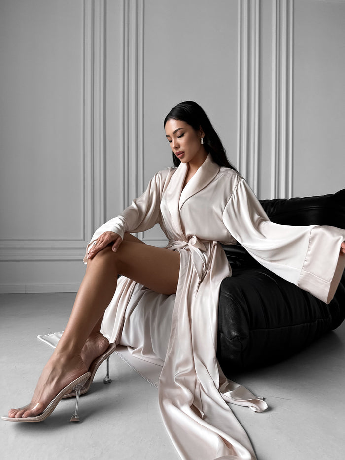 Luxuriate in our Long Silky Robe with Shawl Collar, a sublime fusion of elegance and comfort. Crafted from sumptuous silky fabric, this robe boasts alluring side slits, creating a timeless silhouette perfect for lounging or special occasions. Okiya Studio